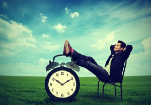 young business man corporate executive relaxing sitting on a chair in the open air outdoors