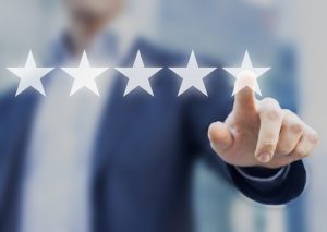 Five stars (5) rating with a businessman touching screen, concept about positive customer feedback and review, excellent performance