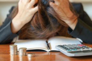 Stressed business woman running out of money - stock and market down