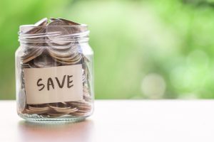 Coins in glass jar for money saving financial concept