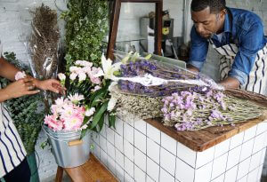 Man using computer laptop in flower shop