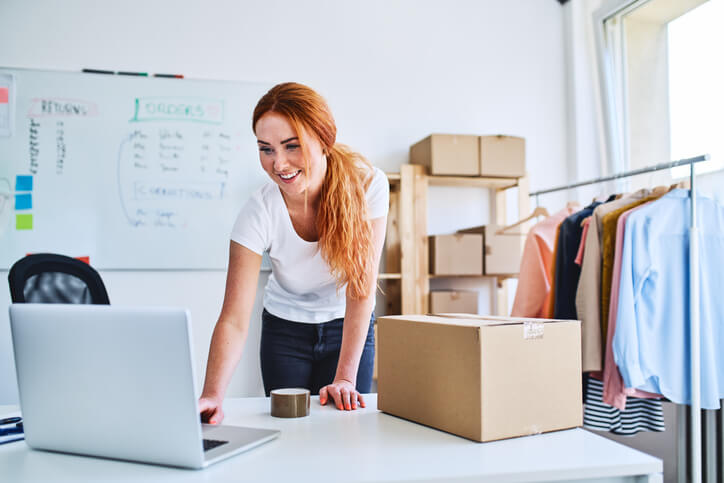 Young lady with computer and boxes