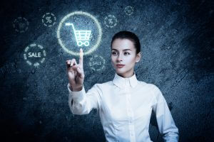 Beautiful Woman Pointing at Glowing Shopping Cart Icon. Perfect Online Shopping Business Concept