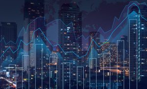 Trading graph on the cityscape at night and world map background,Business financial concept