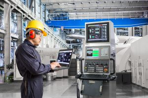 Engineer using computer for maintenance equipment in thermal power plant factory
