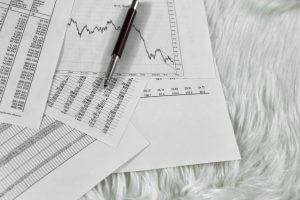 pen on paper with the price quotes and charts the dynamics of their change and coins