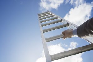 Businessman climbing the corporate ladder of success