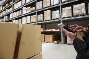 warehouse management , smart logistic concept. Hand holding tablet or cell-phone with application for check order in smart factory warehouse.industry 4.0 concept , mixed media