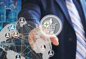 The businessman chooses on the shopping cart on the touch screen with a futuristic background.The concept of online . Auctions.online store. Shopping cart icon. Ecommerce.