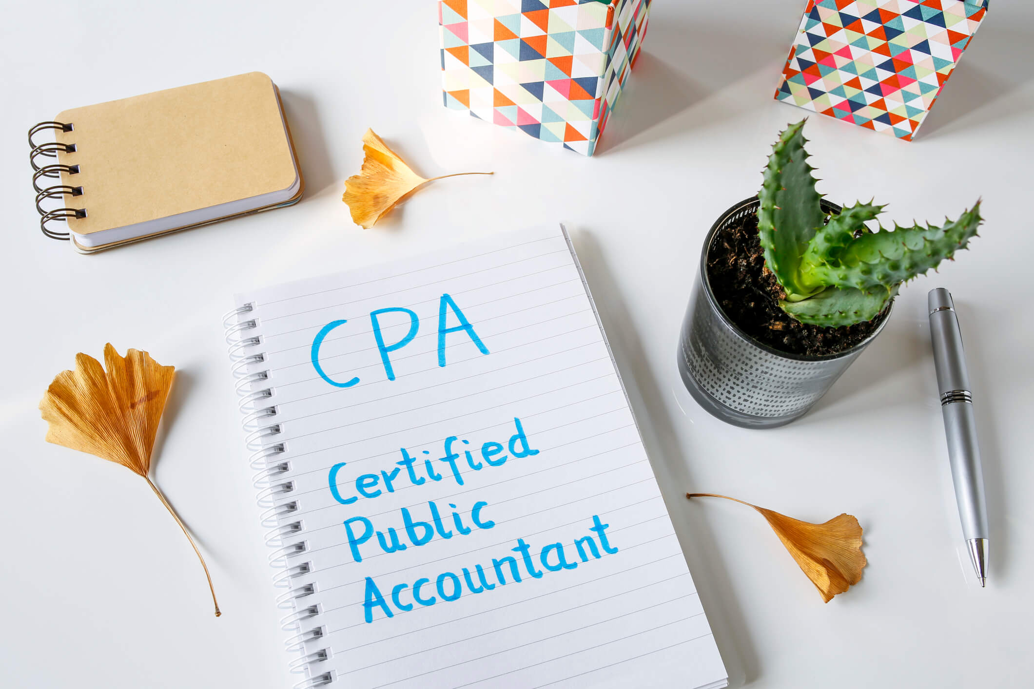 CPA Certified Public Accountant written in notebook on white table